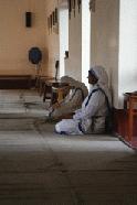 A sister from the Sisters of Charity takes a moment to pray.